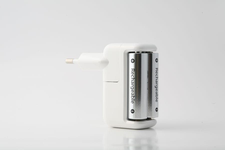 A battery charger with cells on a plain background