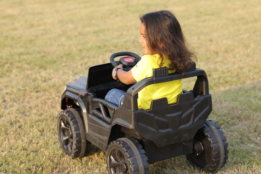 A child playing with a remote control car outdoors