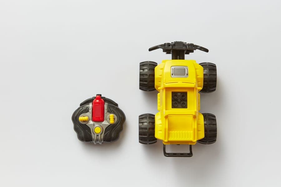 A remote control car beside its transmitter