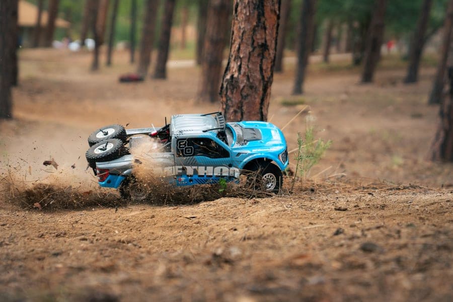 An RC truck kicking up dirt during a fast run