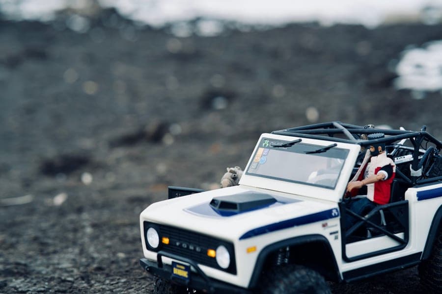An RC monster truck on rocky uneven ground