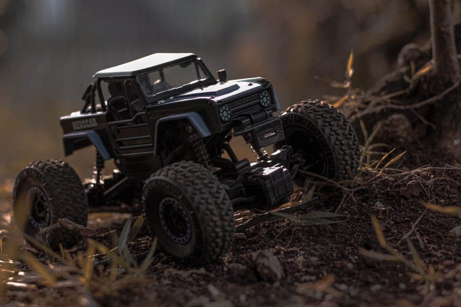 A rugged RC truck on rough outdoor ground