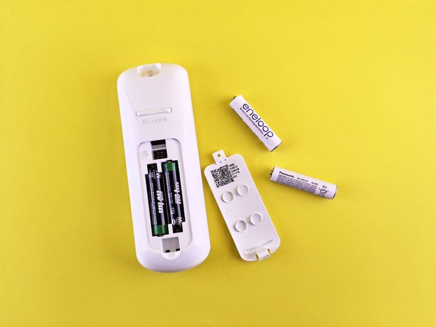 A transmitter beside batteries and accessories